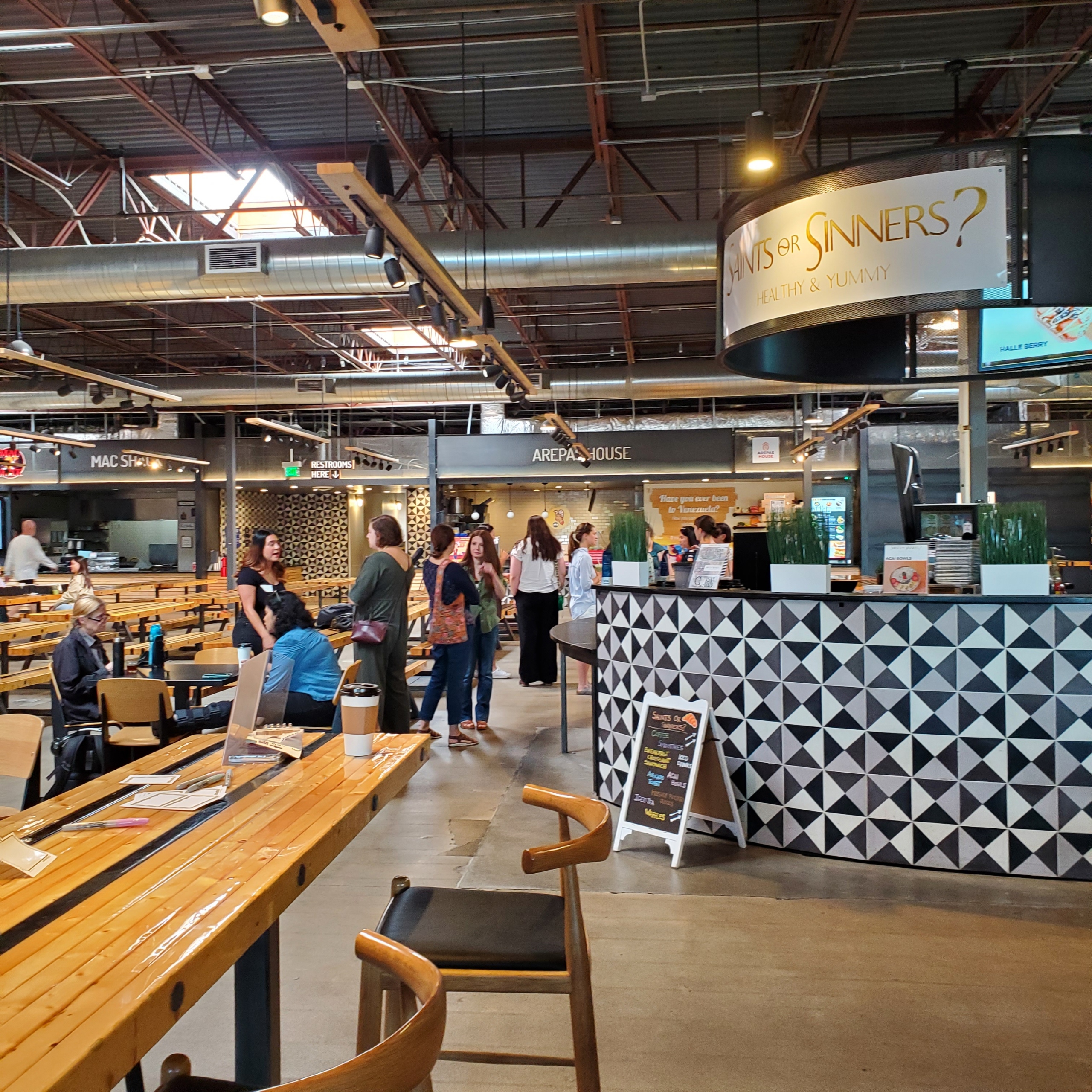 Women&TECH members networking at a food hall meetup
